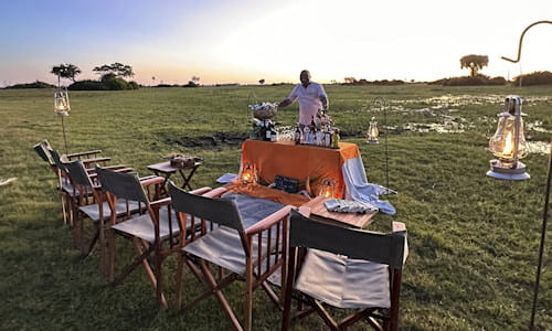 Picnic table and chairs and tour guide, Botswana safari